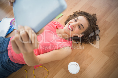 Young creative businesswoman taking a selfie