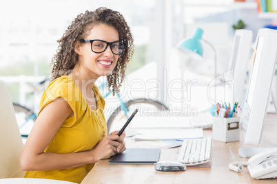 Creative young businesswoman looking at the camera