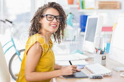 Creative young businesswoman looking at the camera
