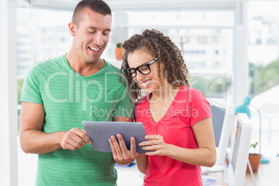 Creative business colleagues holding a tablet