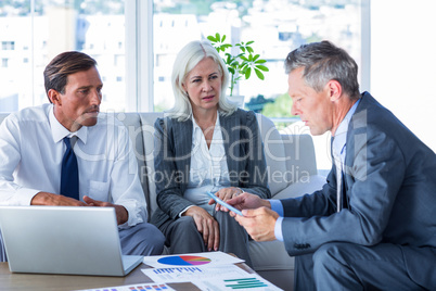 Business people speaking together on couch