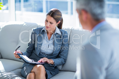 Business people speaking together on couch