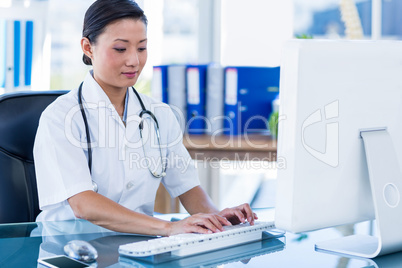 Doctor typing on keyboard