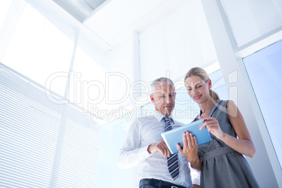 Business people discussing over a digital tablet