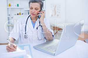 Female doctor having a phone call