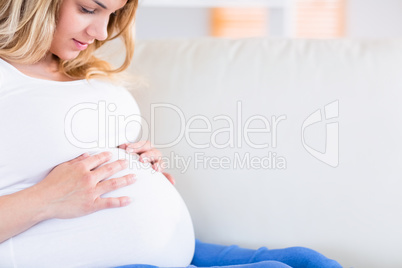 Pregnant woman with hands on her belly