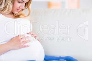 Pregnant woman with hands on her belly