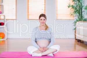Pregnant woman looking at camera