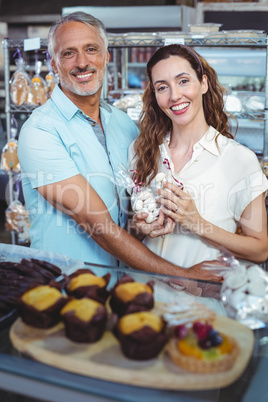 Cute couple looking at camera and standing arm around