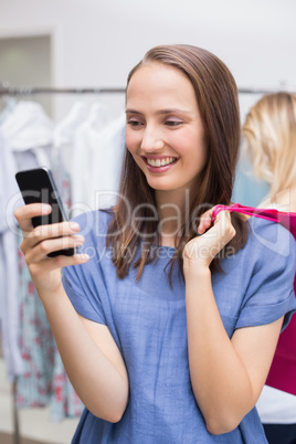 Pretty brunette sending a text message