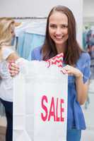 Pretty brunette opening a discounted bag