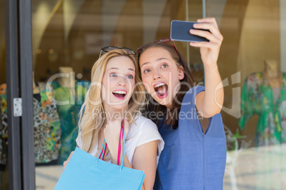 Happy smiling friends taking a selfie