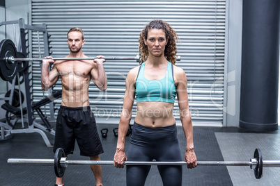 Muscular couple lifting weight together