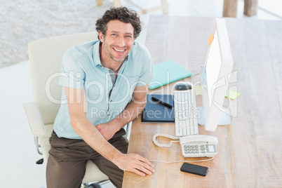 Smiling designer working on his computer Smiling designer working on his computer