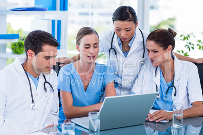 Team of doctors working on laptop