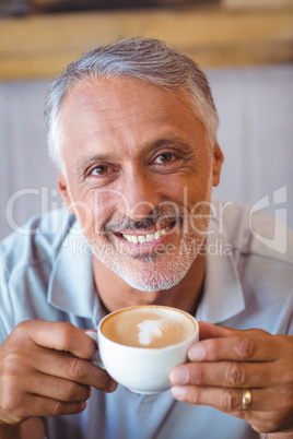 Man sitting in cafe having coffee