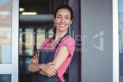 Pretty waitress leaning on the wall