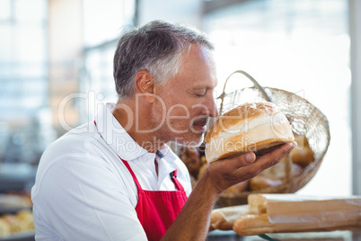 Waiter smelling freshly baked bread