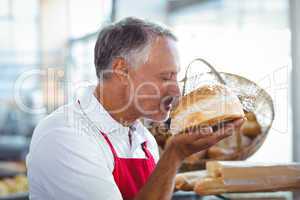 Waiter smelling freshly baked bread