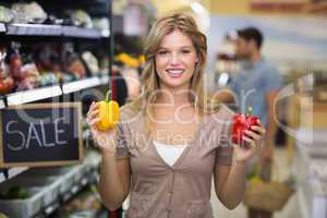 Portrait of a pretty smiling blonde woman buying vegetables