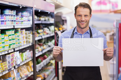 Portrait of a smiling handsome holding a sign