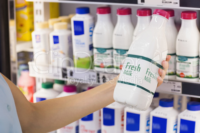 A woman having on her hands a fresh milk bottle