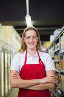 Happy pretty woman looking at camera with arms crossed