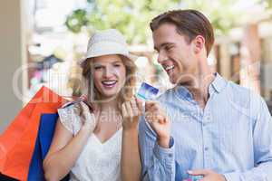 Cute couple handing a credit card