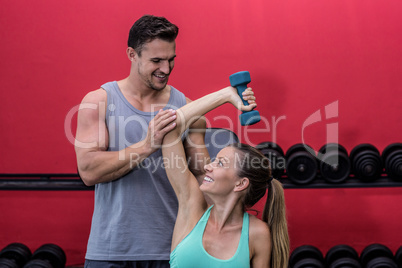 Muscular woman lifting a dumbbell