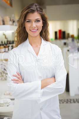 Portrait of smiling beautician with arms crossed