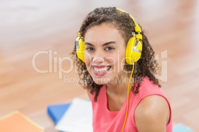 Young creative businesswoman enjoying music