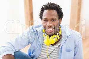 Young creative businessman with headphones around neck