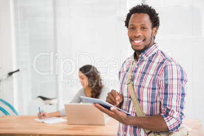 Young businessman smiling at the camera