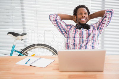 Young businessman relaxes at his place in the office