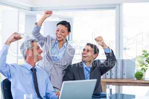 Happy business people cheering together