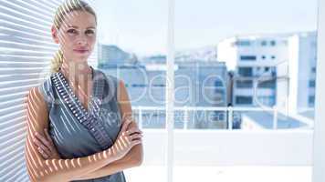 Thoughtful businesswoman standing in the office