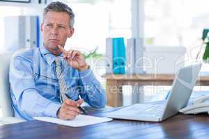 Thoughtful businessman looking away