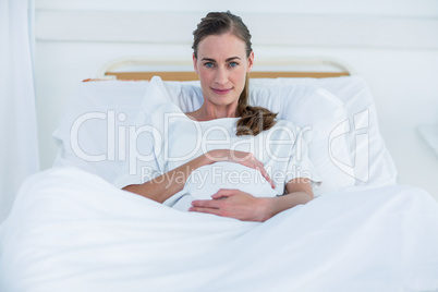 Confident pregnant woman looking at camera