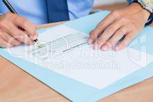 Businessman writing a contrat before signing it