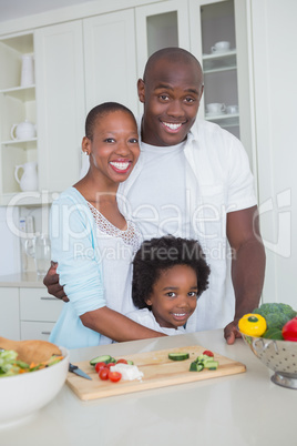 Portrait of a happy family preparing vegetables together