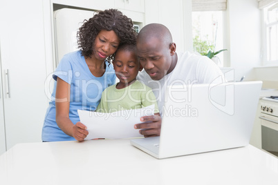 A family working and using his computer