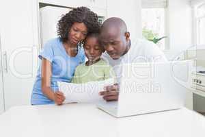 A family working and using his computer