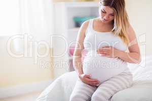 Pregnant woman looking at her belly