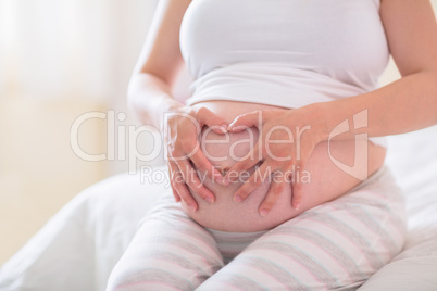 Pregnant woman holding her bump