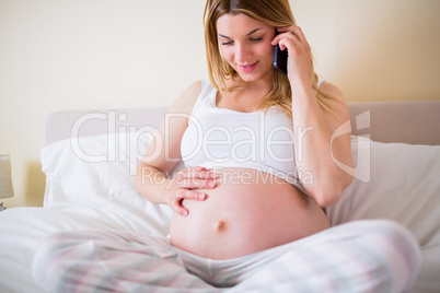 Pregnant woman having phone call