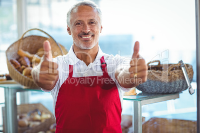 Barista gesturing thumbs up and smiling at camera