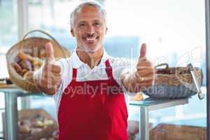 Barista gesturing thumbs up and smiling at camera