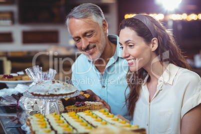 Cute couple looking at cakes