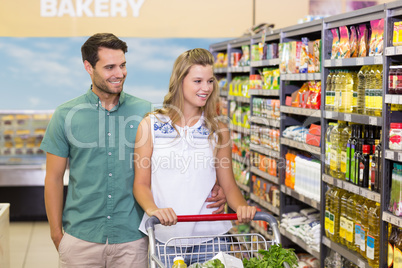 Bright couple buying products in aisle