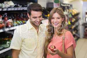 Portrait of smiling bright couple buying food products